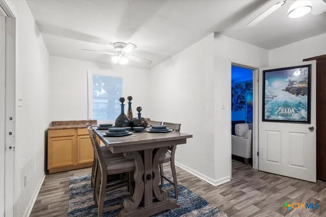 a view of a workspace with furniture and wooden floor