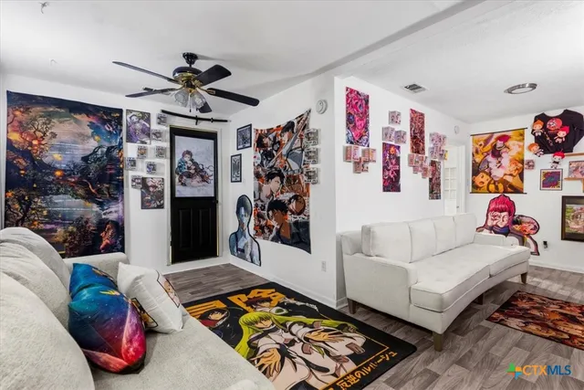 a living room with hard wood floor and a couch