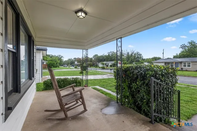 a view of a porch with furniture and garden