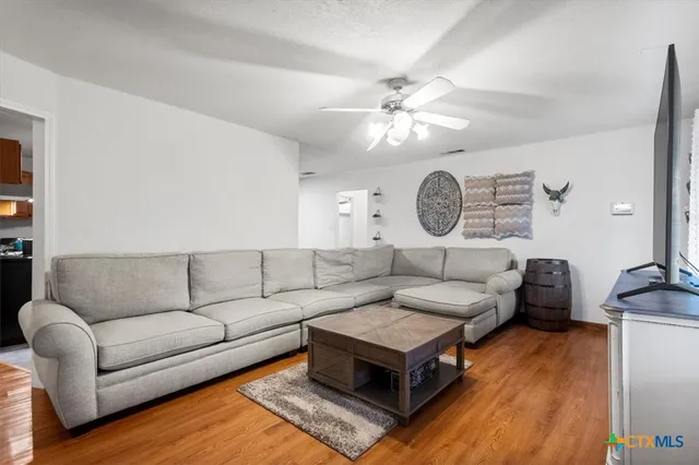 a living room with furniture a clock on wall and a clock