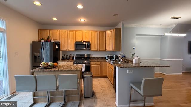 11777 Skylark Road Clarksburg, MD 20871 - Photo 11 of 75 a kitchen with stainless steel appliances kitchen island granite countertop a sink and cabinets