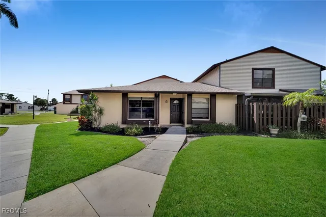 a front view of a house with a yard and porch