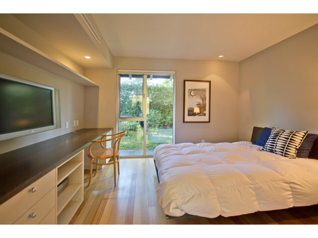 1850 Brookvale Road Hillsborough, CA 94010 - Photo 13 of 24 a bedroom with a bed and a flat screen tv