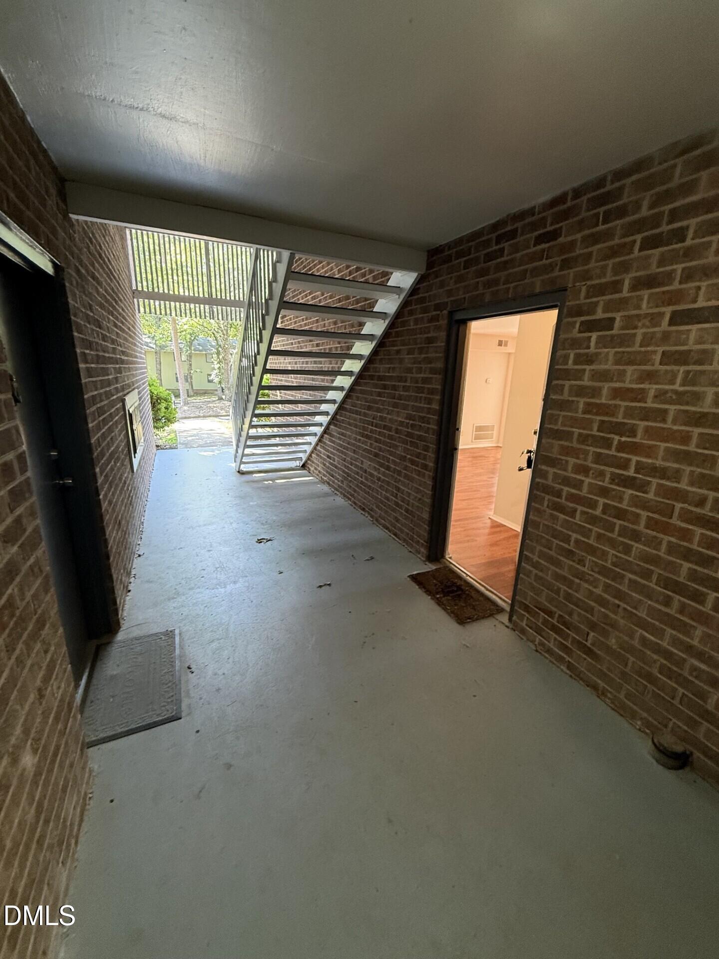 1299 Schaub Drive, Unit D Raleigh, NC 27606 - Photo 14 of 16 a view of an empty room with wooden floor and a window