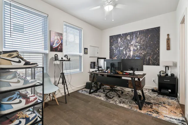 a view of a livingroom with workspace and a window