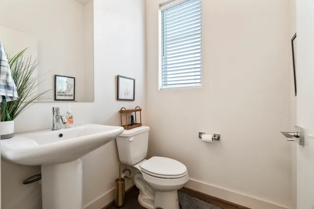 a bathroom with a sink toilet and a mirror