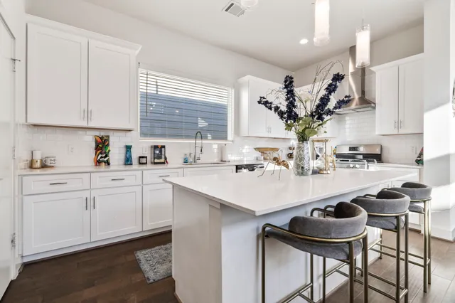 a kitchen with a sink cabinets and window