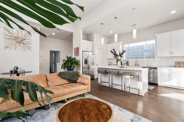 a living room with kitchen island furniture and a fireplace