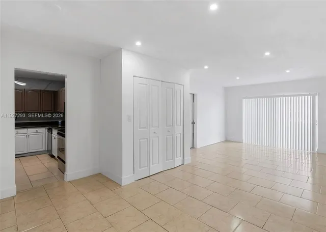 a view of a kitchen with an empty space and a window