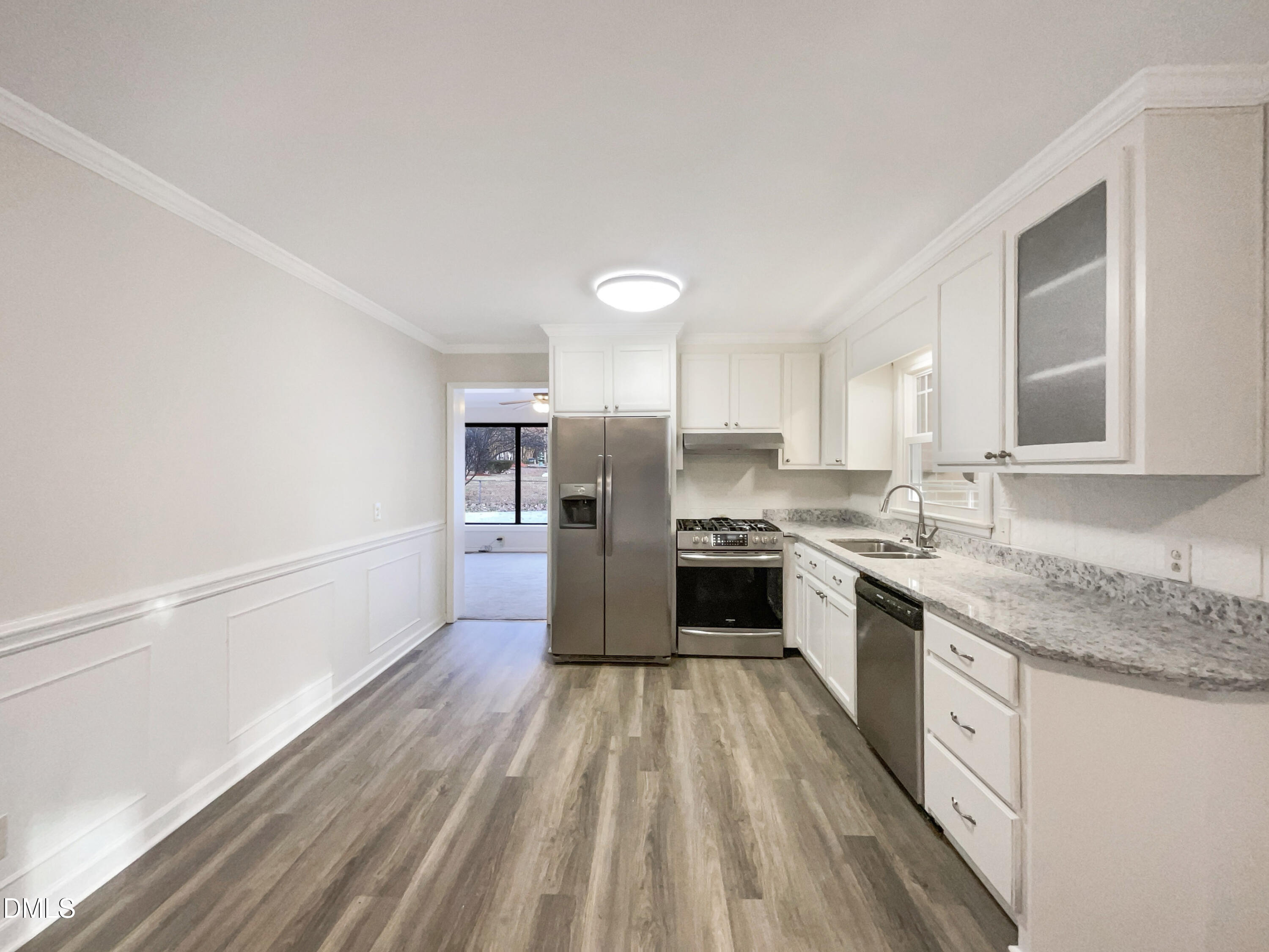 106 Foust Road Mebane, NC 27302 - Photo 15 of 18 a large kitchen with a center island wooden floor and stainless steel appliances