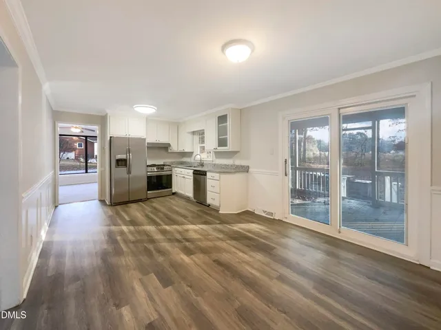 a view of a kitchen with a sink and refrigerator