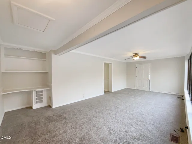 an empty room with a empty space and windows