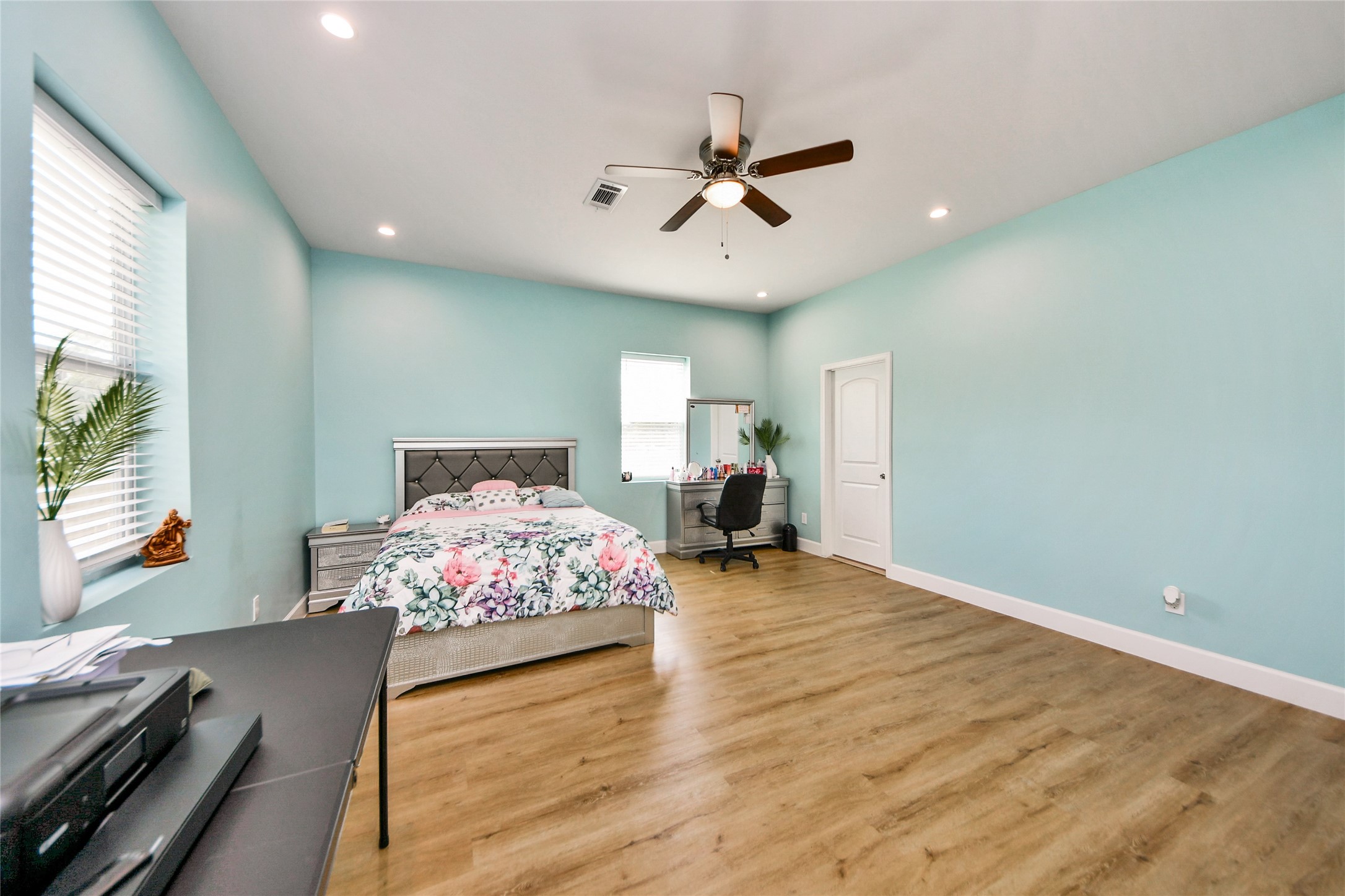 12128 County Road Cleveland, TX 77327 - Photo 16 of 27 a bedroom with a bed and wooden floor