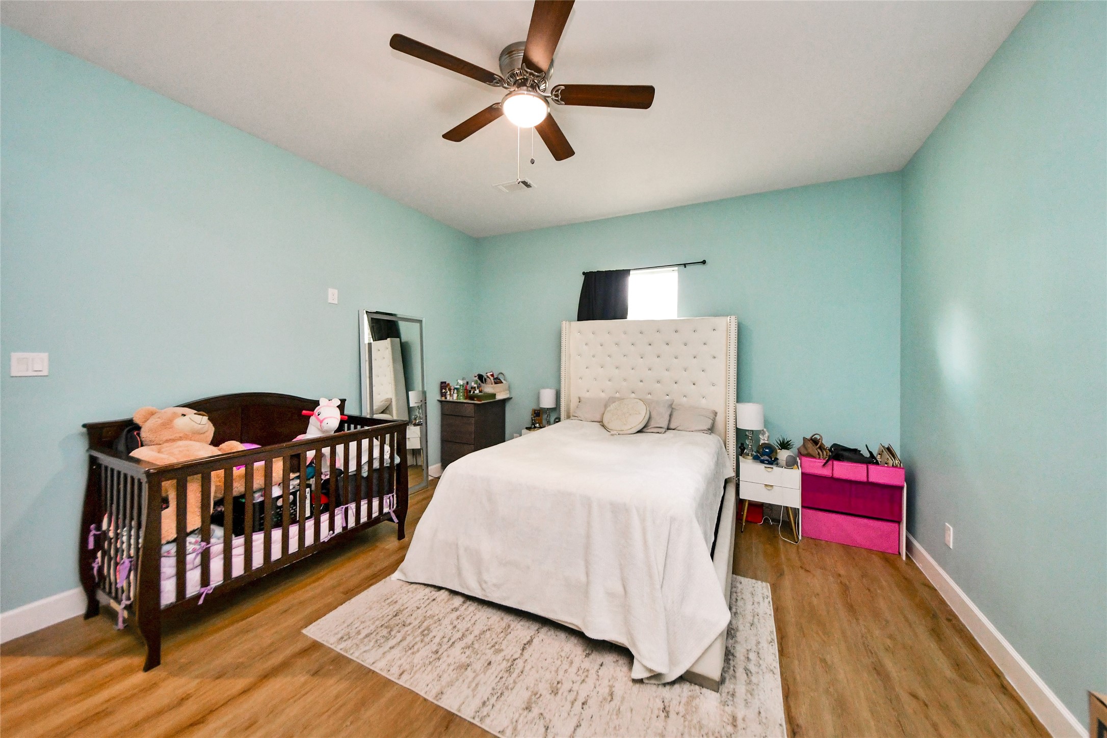 12128 County Road Cleveland, TX 77327 - Photo 18 of 27 a bedroom with bed and wooden floor