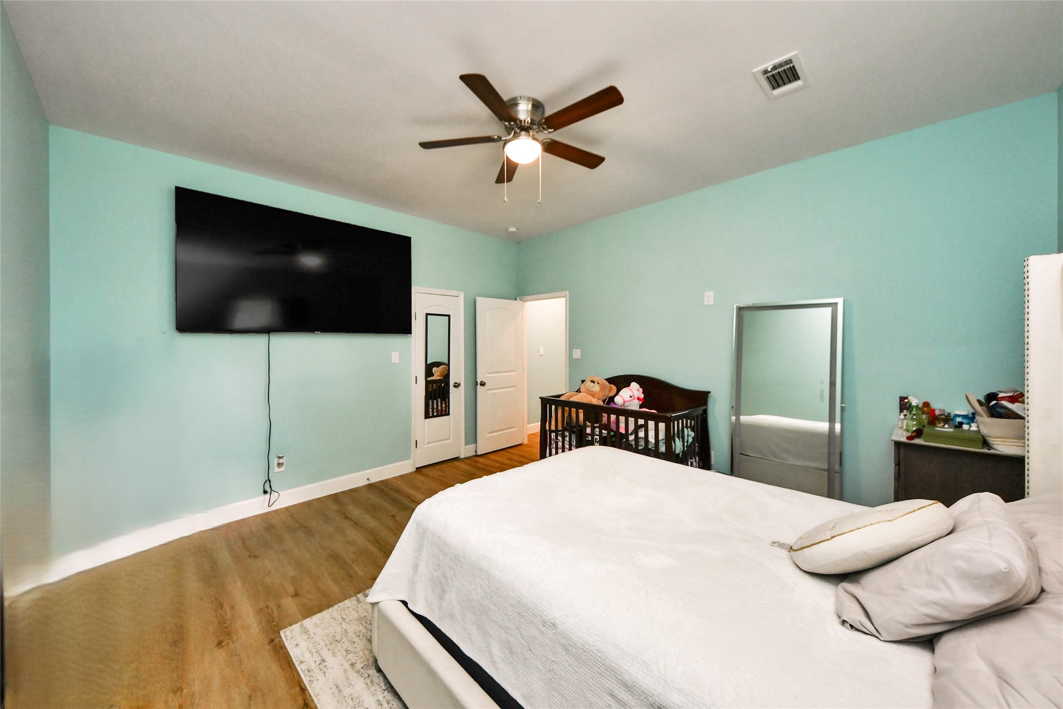 12128 County Road Cleveland, TX 77327 - Photo 19 of 27 a bedroom with a bed and a flat screen tv