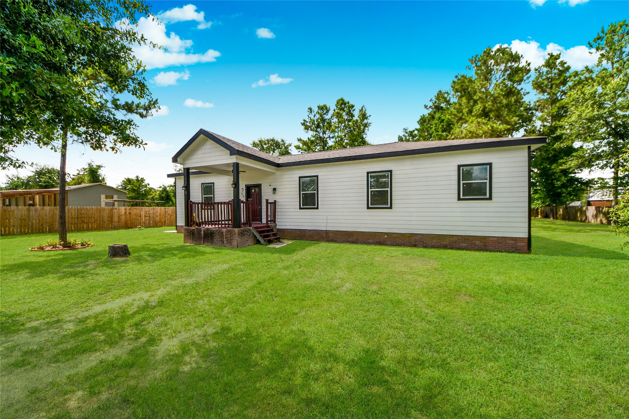 12128 County Road Cleveland, TX 77327 - Photo 2 of 27 a view of a house with a backyard
