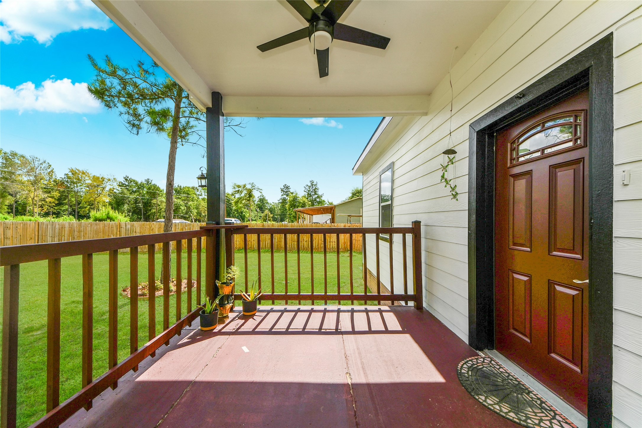 12128 County Road Cleveland, TX 77327 - Photo 4 of 27 a view of a balcony with a potted plant
