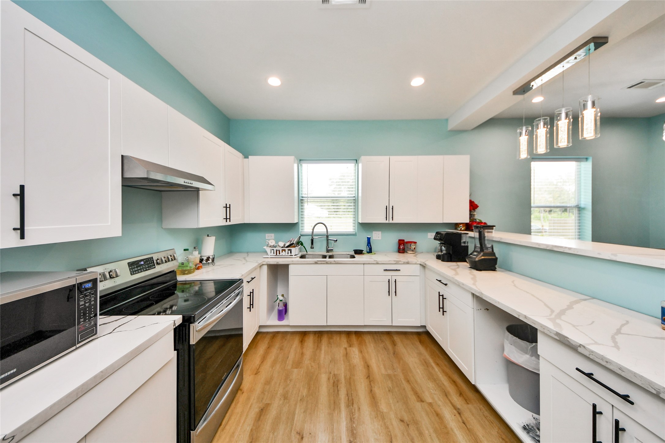 12128 County Road Cleveland, TX 77327 - Photo 9 of 27 a kitchen with a sink stove and cabinets