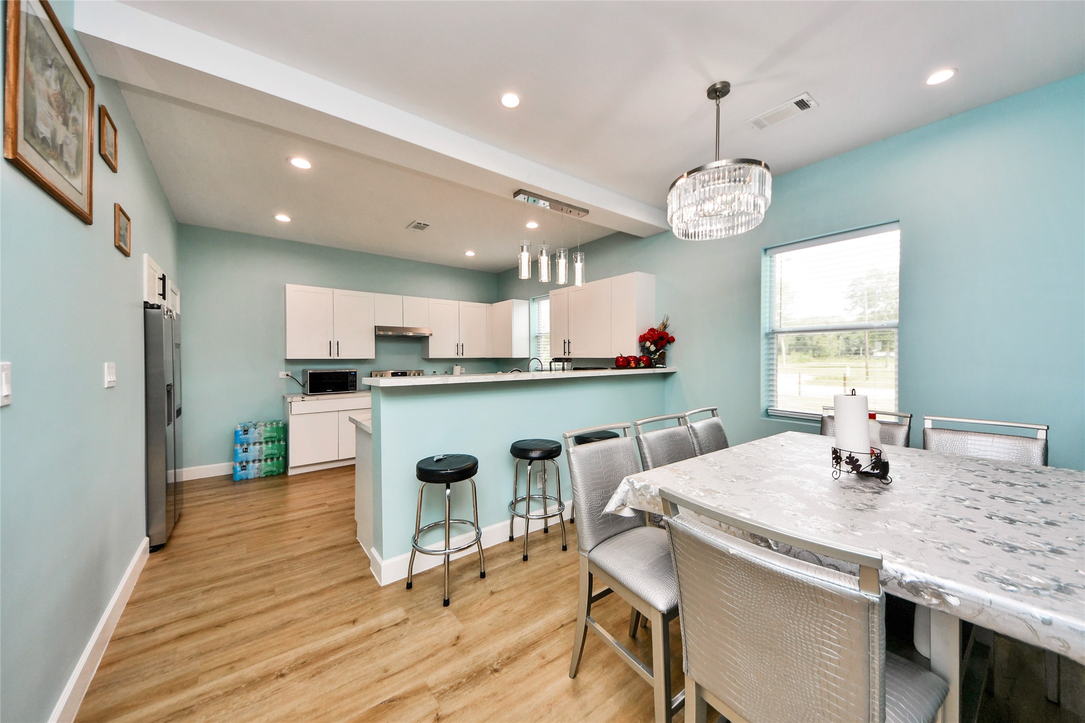 12128 County Road Cleveland, TX 77327 - Photo 10 of 27 a kitchen with a table and chairs in it