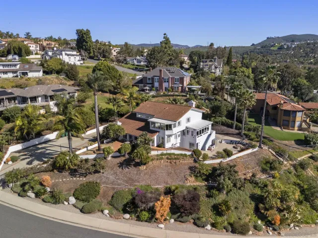 a front view of a house with a tree