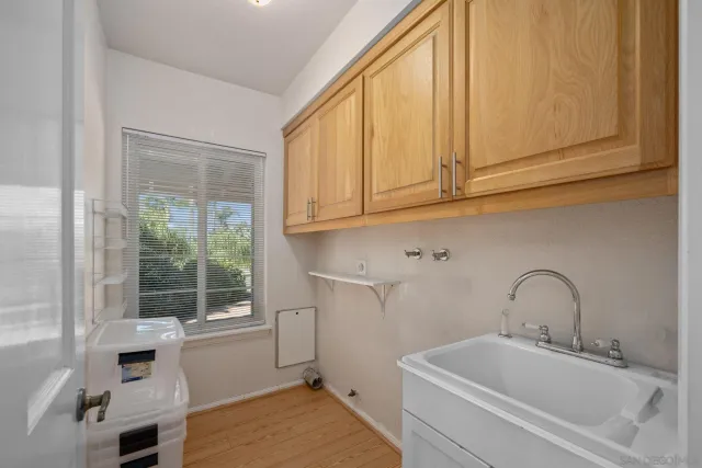 a bedroom with a large bed and dresser with mirror