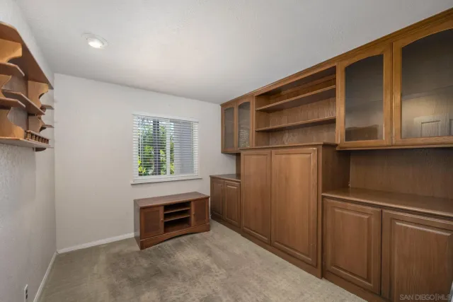 a bathroom with a granite countertop sink toilet and a mirror