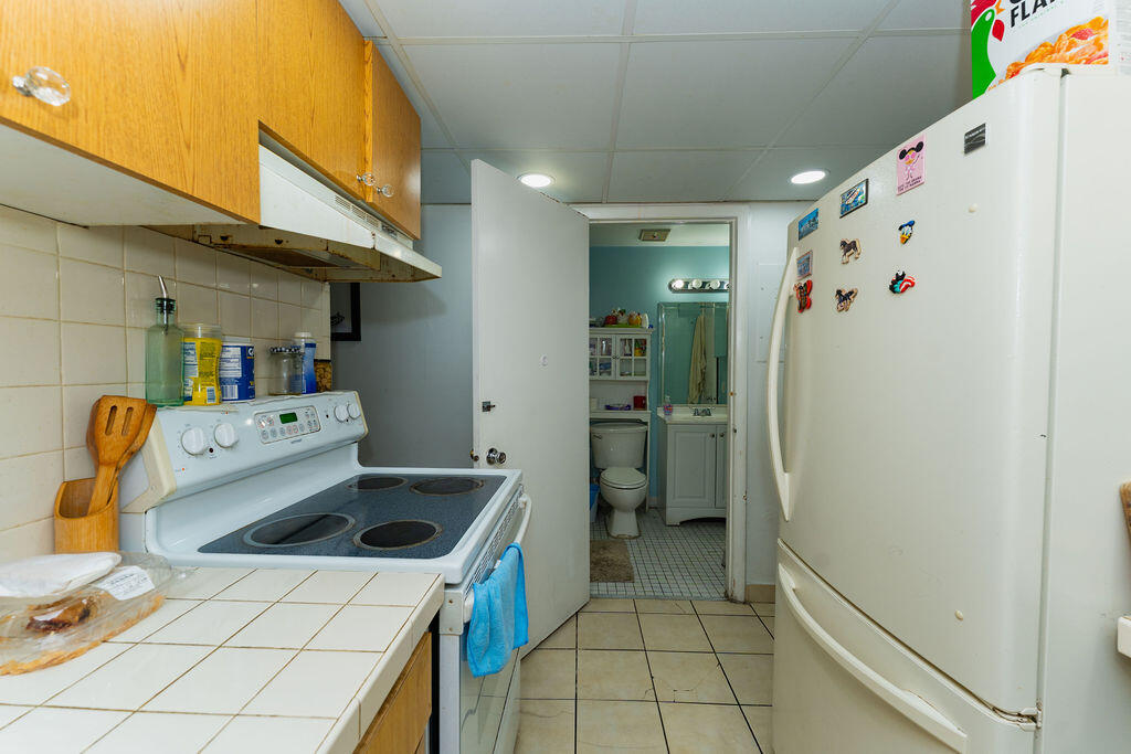 777 Southwest 9th Avenue, Unit 409 Miami, FL 33130 - Photo 15 of 32 a kitchen with a sink a refrigerator and washer
