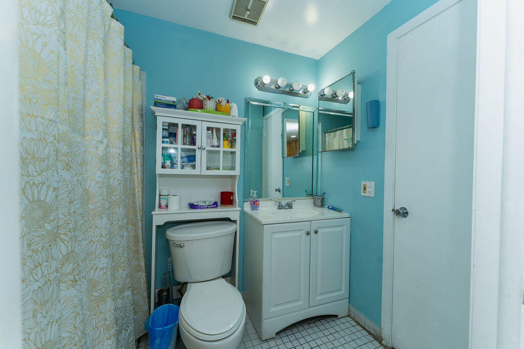 777 Southwest 9th Avenue, Unit 409 Miami, FL 33130 - Photo 16 of 32 a bathroom with a toilet a sink and mirror