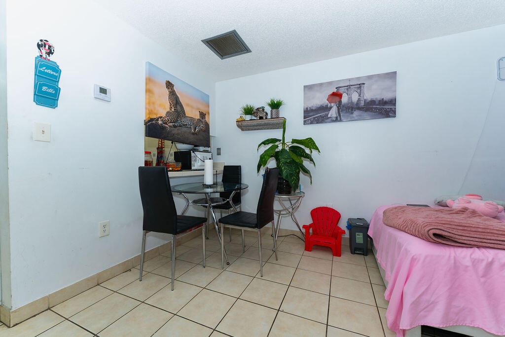 777 Southwest 9th Avenue, Unit 409 Miami, FL 33130 - Photo 17 of 32 a bedroom with furniture and a potted plant