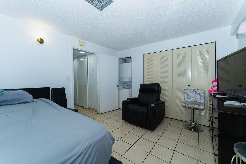 777 Southwest 9th Avenue, Unit 409 Miami, FL 33130 - Photo 8 of 32 a bedroom with a bed and a television in it