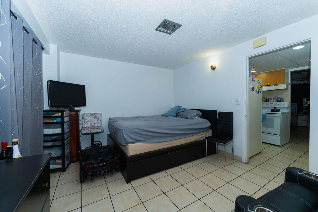 777 Southwest 9th Avenue, Unit 409 Miami, FL 33130 - Photo 9 of 32 a bedroom with furniture and a flat screen tv