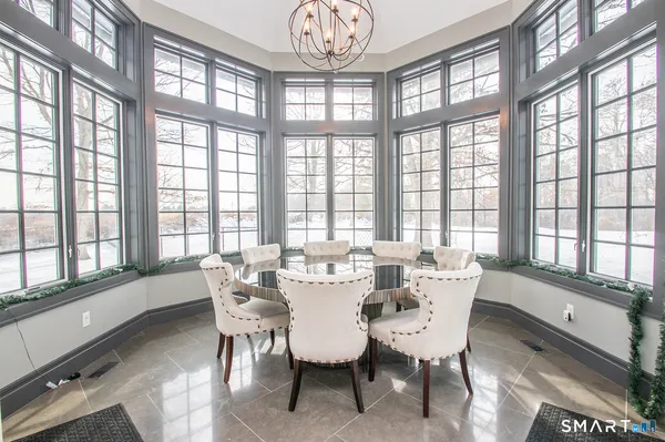 a dining room with furniture a chandelier and a rug