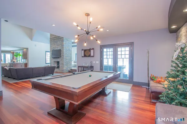 a room with pool table and windows
