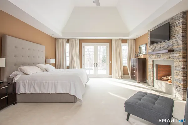 a spacious bedroom with a bed and a couch