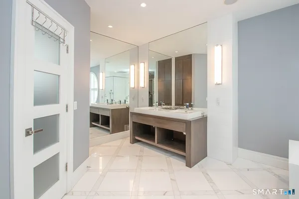 a spacious bathroom with a sink and a mirror