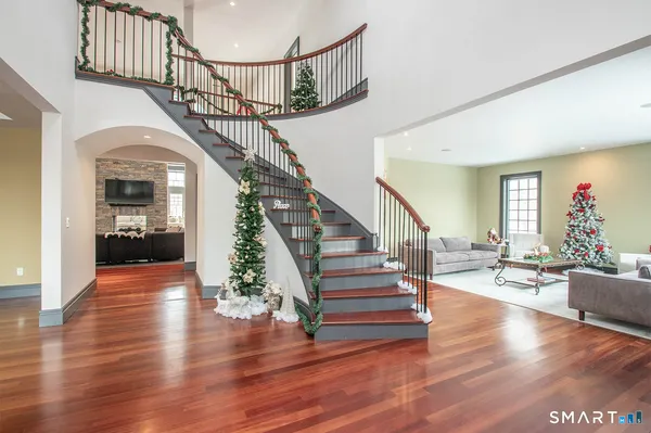 a view of entryway and hall with wooden floor