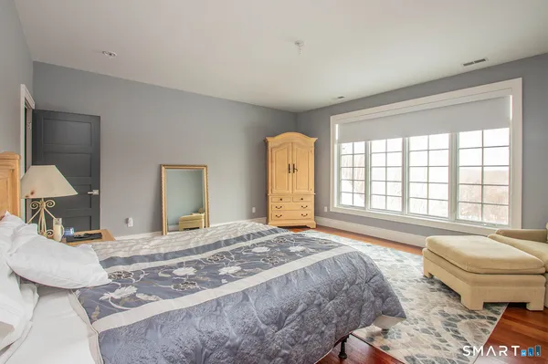 a bedroom with a large bed and a window