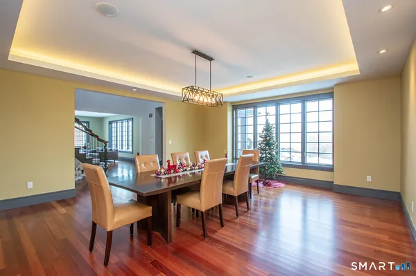 a dining room with furniture window and wooden floor
