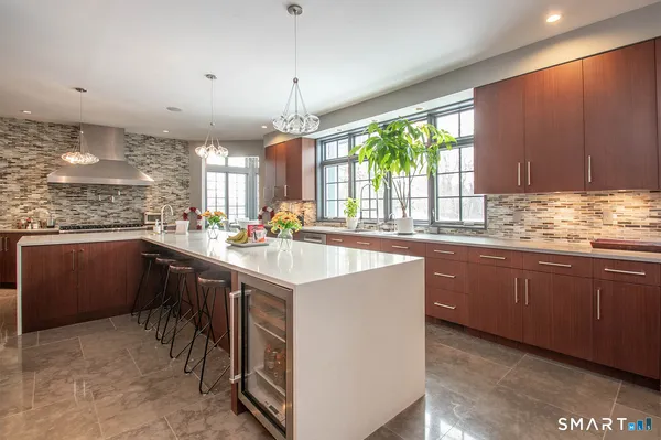 a kitchen with stainless steel appliances granite countertop sink stove and refrigerator