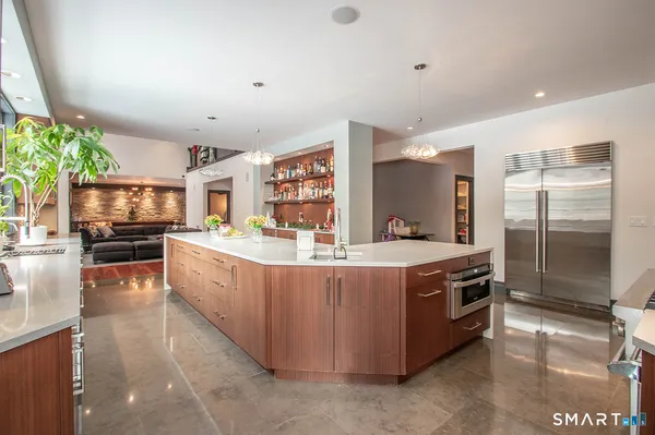 a kitchen with stainless steel appliances granite countertop a stove and a refrigerator
