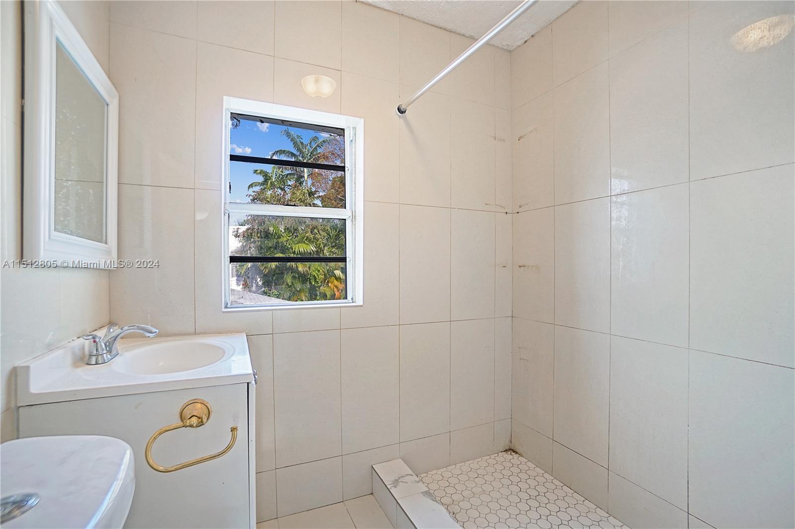 1924 Southwest 9th Street Miami, FL 33135 - Photo 11 of 23 a bathroom with a toilet a sink a window and mirror