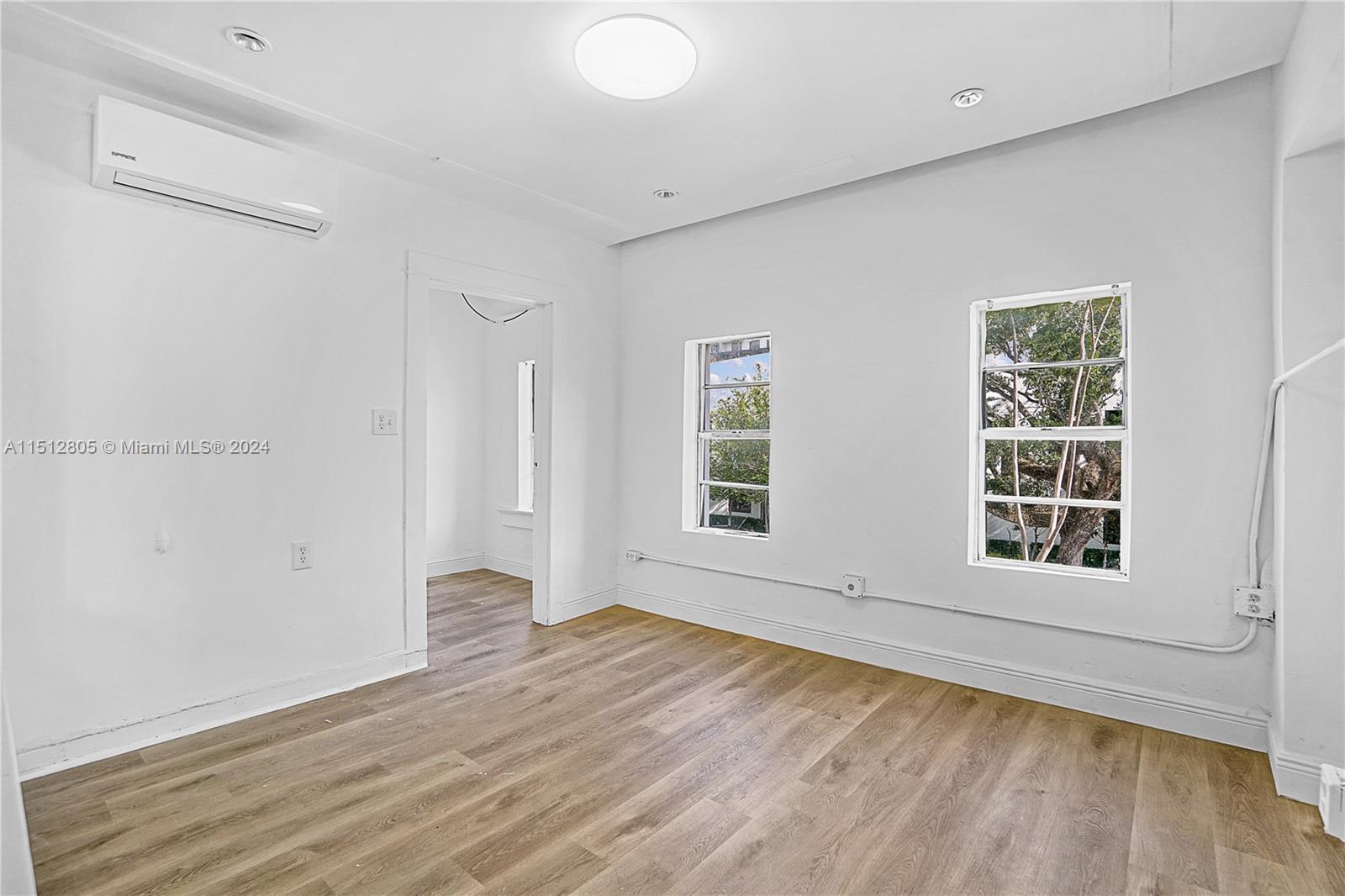 1924 Southwest 9th Street Miami, FL 33135 - Photo 12 of 23 an empty room with wooden floor and windows