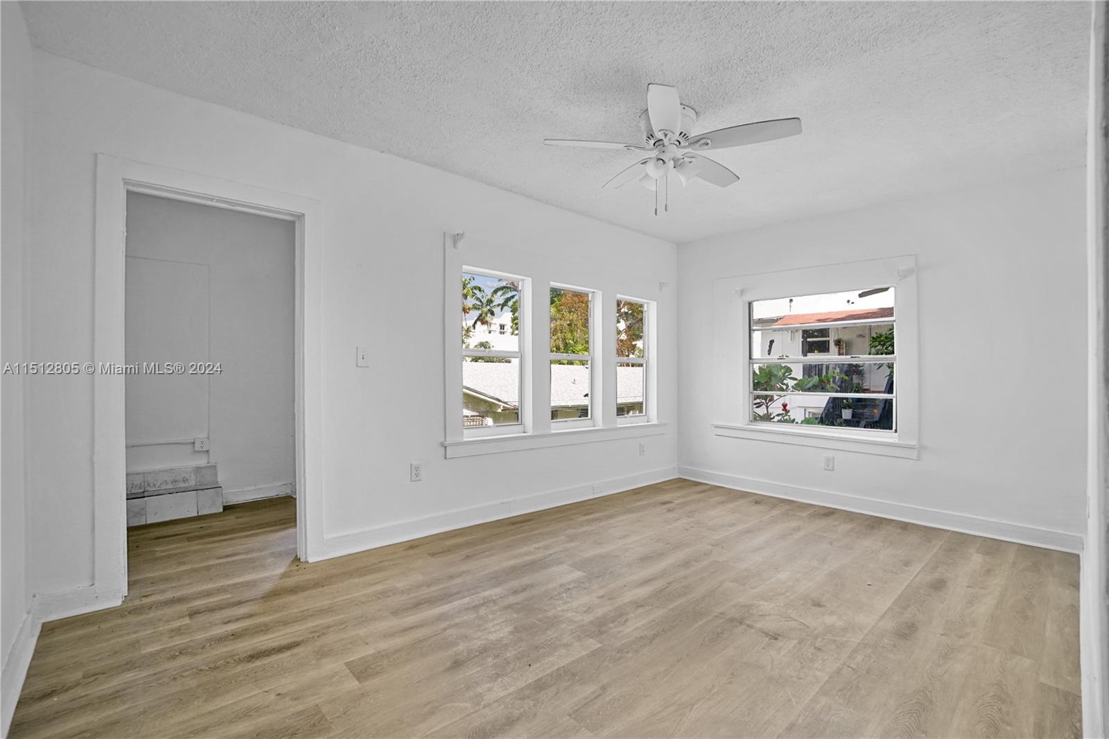 1924 Southwest 9th Street Miami, FL 33135 - Photo 17 of 23 a view of an empty room with a window and wooden floor