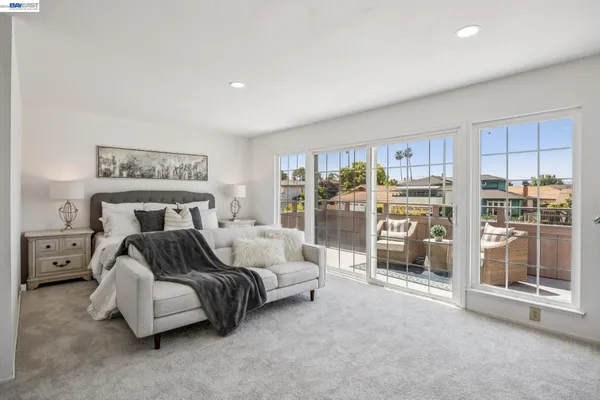 a bedroom with a bed and a large window