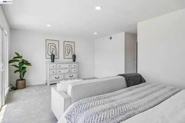 a bedroom with a bed and a potted plant