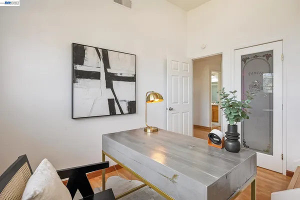 a bedroom with a bed and painting on the wall