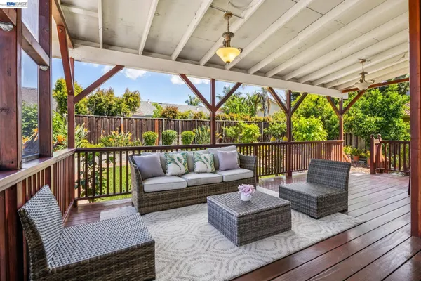 a balcony with furniture and wooden floor