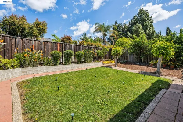 a view of a house with backyard sitting area and garden