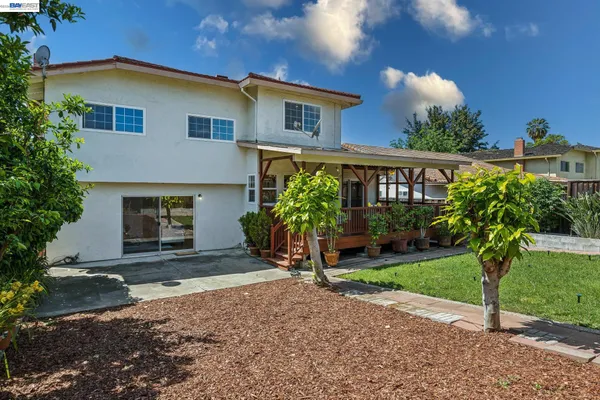 a view of house with yard and green space