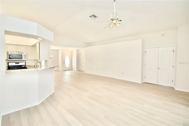 a kitchen with white cabinets and white appliances